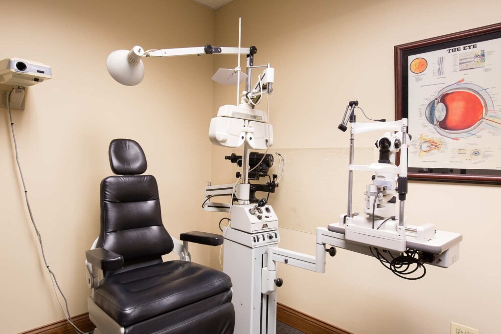An ophthalmology examination room with a patient chair and slit lamp